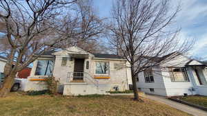 Bungalow-style home featuring a front yard and brick siding