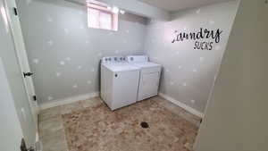 Laundry area with washer and clothes dryer and light tile patterned floors