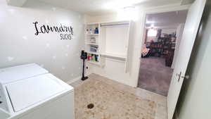 Laundry area with separate washer and dryer and a textured ceiling