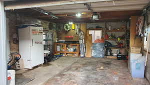 Garage with  a workshop area, and a garage door opener