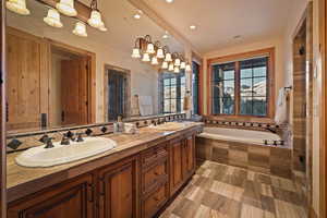 Full bathroom with a garden tub, double vanity, a shower stall, and recessed lighting
