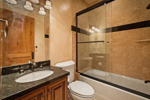Full bathroom featuring vanity and combined bath / shower with glass door