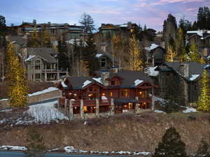 Snow covered property with a balcony