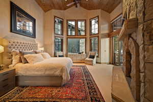Bedroom with a high wooden ceiling and light carpet