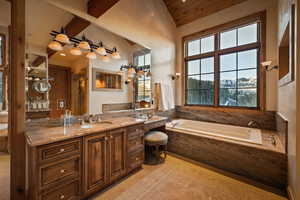 Bathroom with vanity and a bath