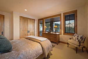 Carpeted bedroom with a closet and recessed lighting