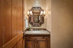 Bathroom featuring a textured wall and vanity