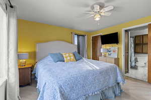 Bedroom featuring ceiling fan, a closet, and wood finished floors