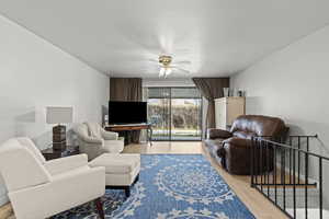 Living room featuring wood finished floors and ceiling fan