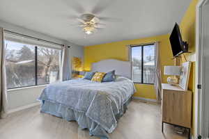 Bedroom featuring a ceiling fan and light wood-type flooring