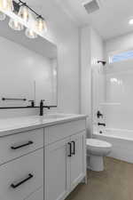 Full bath featuring vanity,  shower combination, and light tile patterned floors