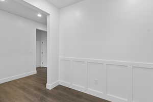 Spare room featuring dark wood-style floors and recessed lighting