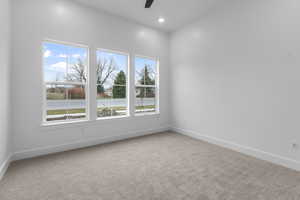 Unfurnished room featuring light carpet, a ceiling fan, and recessed lighting
