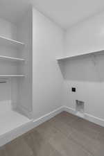 Washroom with baseboards and electric dryer hookup