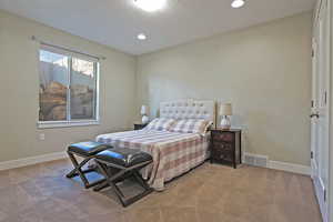 Carpeted bedroom featuring recessed lighting and a textured ceiling