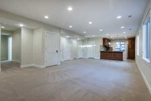 Unfurnished living room with recessed lighting and light colored carpet