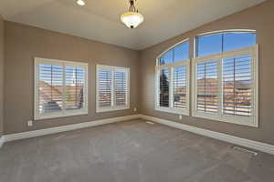 Unfurnished room featuring baseboards and carpet flooring