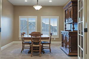 Dining space featuring light carpet and recessed lighting