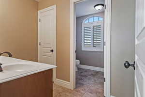 Bathroom featuring vanity and baseboards
