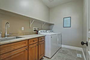 Laundry room with washer and dryer and cabinet space