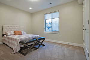 Bedroom with light carpet, recessed lighting, and a textured ceiling