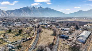 Aerial view of property and surrounding area with a mountain backdrop