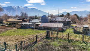 View of yard featuring a mountain view, an outbuilding, and an exterior structure