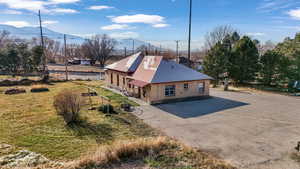 View of home's exterior with brick siding, a lawn, and driveway