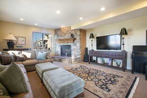 Living area featuring a fireplace, carpet, and recessed lighting