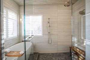Full bathroom with a freestanding tub and a tile shower