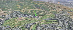 Aerial view of neighboring golf course, mountains and national forest