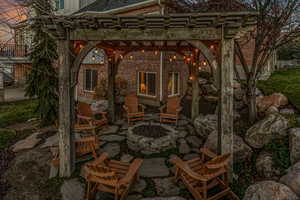 View of patio with an outdoor fire pit