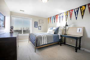 Carpeted bedroom featuring baseboards
