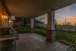 Porch with a fenced backyard and grilling area
