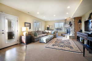 Carpeted living area featuring a fireplace and recessed lighting