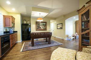 Rec room featuring dark wood-type flooring, recessed lighting, and arched walkways