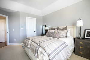 Carpeted bedroom with baseboards