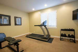 Workout area with carpet floors and recessed lighting