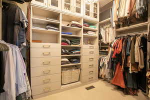 Walk in closet with light colored carpet