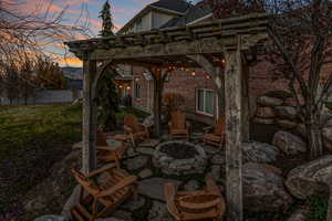 View of patio / terrace with an outdoor fire pit and a pergola