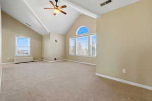 Large master bedroom with carpet, a ceiling fan, and high vaulted ceiling