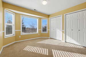 3rd bedroom with two closets and carpet