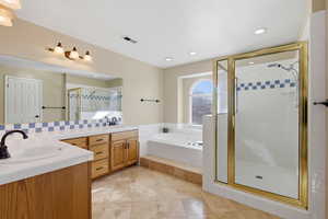 Bathroom with a shower stall, double vanity, a bath, light tile patterned floors, and recessed lighting