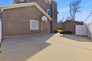 View of side of property with stucco siding, extra RV parking and  spacious side shed