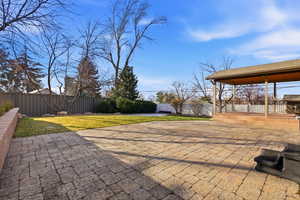 Fenced backyard featuring  stunning rock  patio