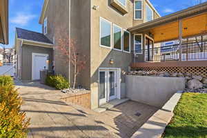 Back of house featuring stucco siding and a wooden deck