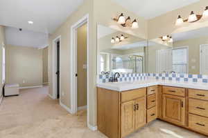 Full bathroom with vanity, a shower stall, decorative backsplash, and light tile patterned flooring