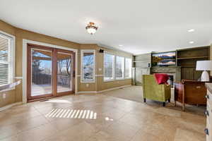 Living area with a tile fireplace and recessed lighting