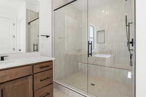 Bathroom featuring a stall shower and vanity