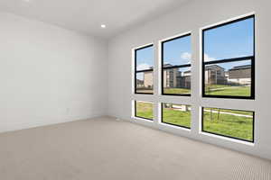 Spare room with light colored carpet and recessed lighting